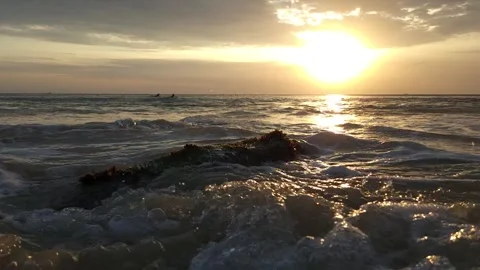 Wave Breaking Over a Mossy Rock at Dreamland Beach, Bali at Sunset Stock Footage 340390961