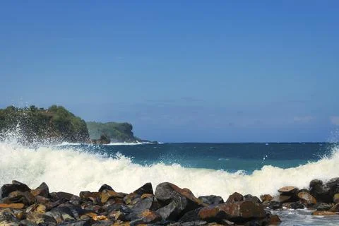 Wave Breaking over The Rocks Stock Photos