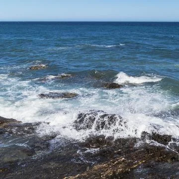 Wave breaking on rock. Stock Photos