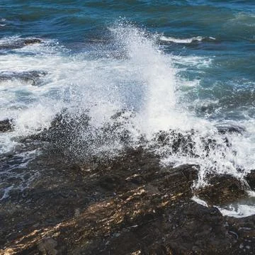 Wave breaking on rock. Stock Photos