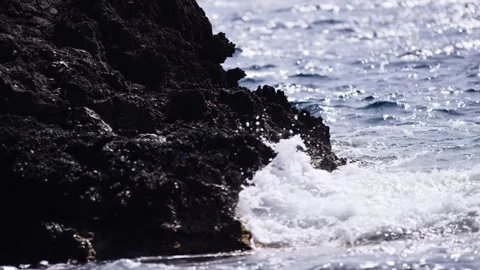 Wave Breaking On Rock By Sparkling Sunlit Sea, Bokeh Reflections, Low Shot Stock Footage 340627102