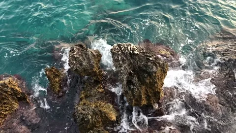 Wave breaking on rocks Stock Footage 135934107