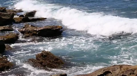 Wave breaking on rocky coast Stock Footage 49879749