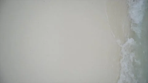 A wave breaking on a white sand beach, vertical video Stock Footage 146709361