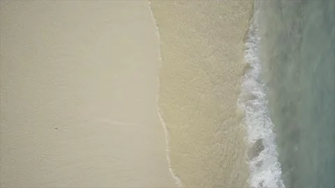 A wave breaking on a white sand beach Stock Footage 146971969