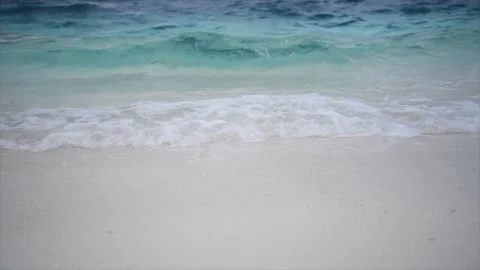 A wave breaking on a white sand beach Stock Footage 146972131