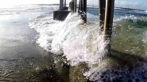 Wave breaks over ocean rock pool slow motion Mona Vale Australia Видео 54468448