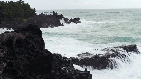 Wave breaks on the rocks at eastern shore of Jeju-do Island, South Korea Stock Footage 289420356