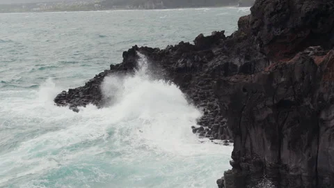 Wave breaks on the rocks at eastern shore of Jeju-do Island, South Korea Stock Footage 289420704