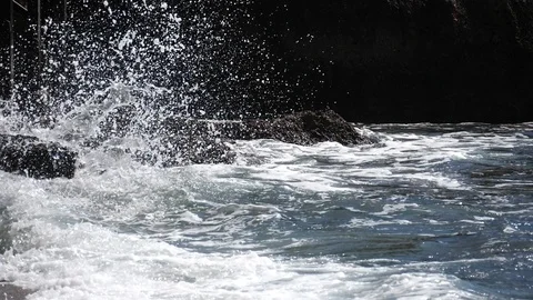 Wave breaks on the rocks, super slow motion Stock Footage 88527337