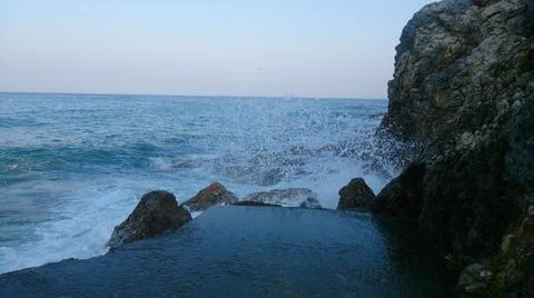 A wave breaks on the shore Stock Photos