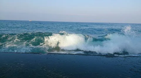 A wave breaks on the shore Stock Photos
