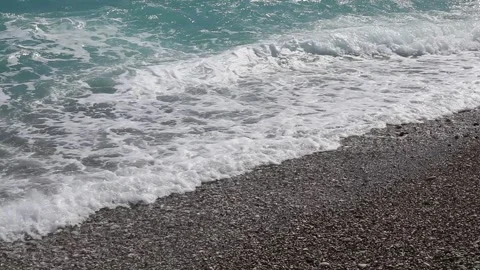 Wave breaks slow motion on a pebble beach Stock Footage 153834001