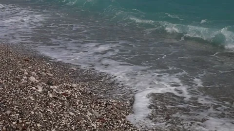 Wave breaks slow motion on a pebble beach Stock Footage 153834039
