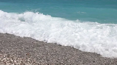 Wave breaks slow motion on a pebble beach Stock Footage 153834079