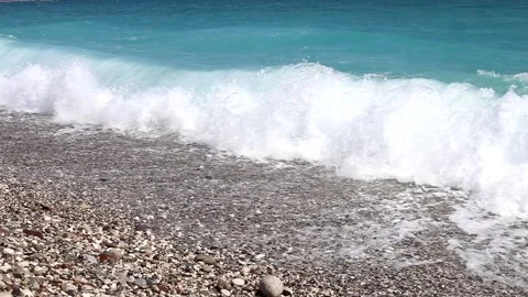 Wave breaks slow motion on a pebble beach Stock Footage 153834176