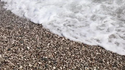 Wave breaks slow motion on a pebble beach Stock Footage 153834190