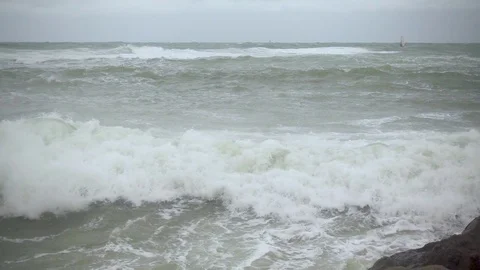 The wave breaks with splashes on boulders slow mo Stock Footage 82034752