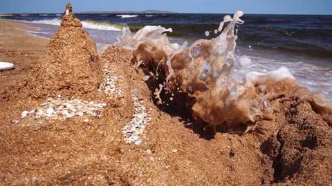 Wave breaks wall of sand the castle Stock Footage 114190358
