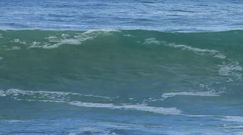 Wave builds in open ocean, crests and breaks left to right camera follows GF Video stock 32285960