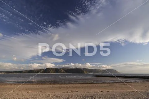 Wave cloud over Llandudno West Shore at sunset, North Wales coast Stock Photos