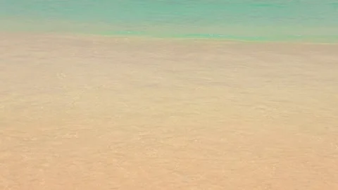 Wave coming and going, calm warm idyllic ocean tide, yellow sand and milky ocean Stock Footage 202122514
