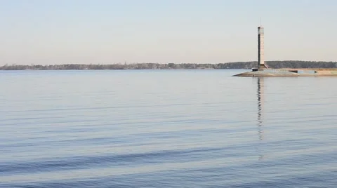 Wave-covered water surface with breakwater and lighthouse on it Stock Footage 49689185