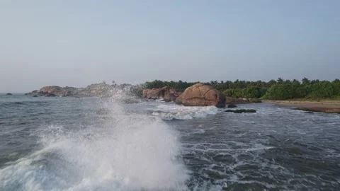 The wave crashes against the rock of the coast of Sri Lanka Stock Footage 225864610
