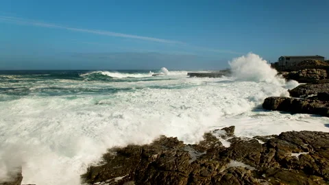 Wave crashes and runs onto rocks of rocky coastline; rough ocean Stock Footage 194436668