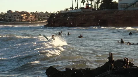 Wave Crashes over Surfers 動画素材 196838309