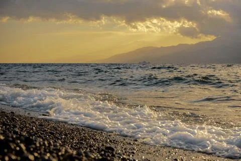 A wave crashes on the seashore Stock Photos