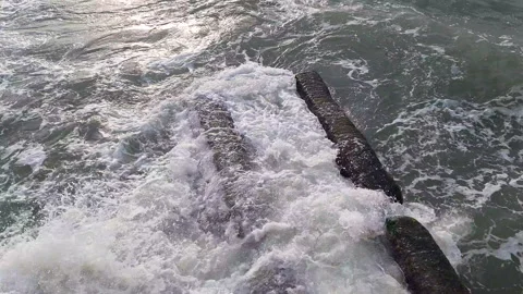 Wave crashes in slow motion onto rocks with foam and water flying in all Stock Footage 167292166