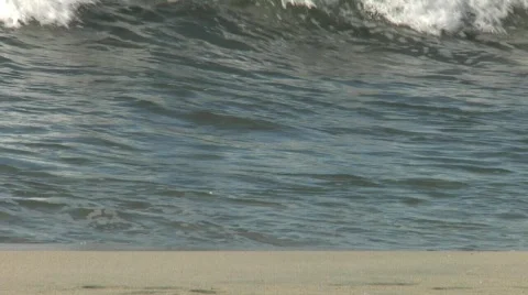 Wave crashing onto beach Stock Footage 590487