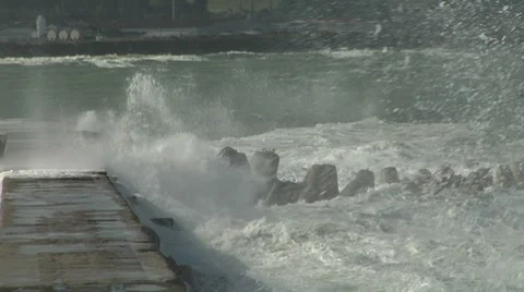 Wave crashing over outlet pipe rough seas Stock Footage 8509720