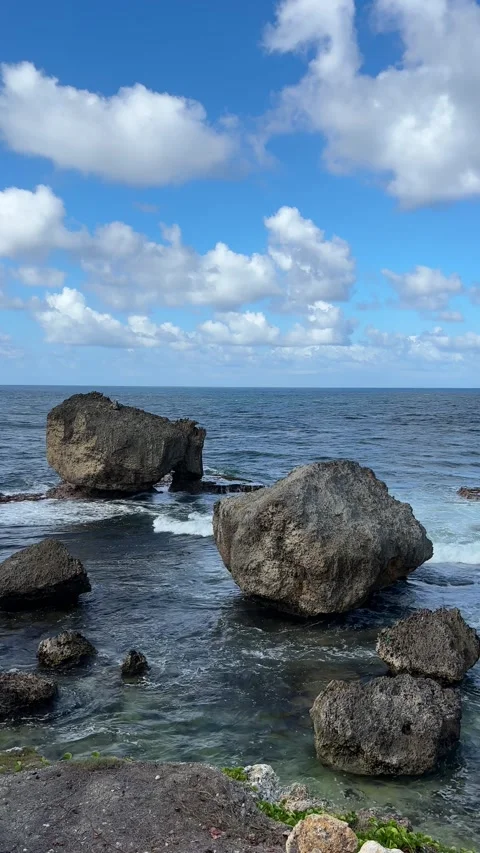 Wave crashing over rocks into clear sea water pool Caribbean Stock-Footage 334130920