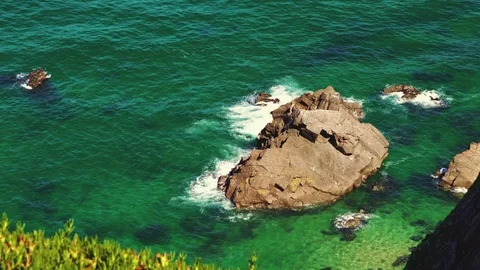 Wave crashing on the rocks of beach Stock Footage 93499170