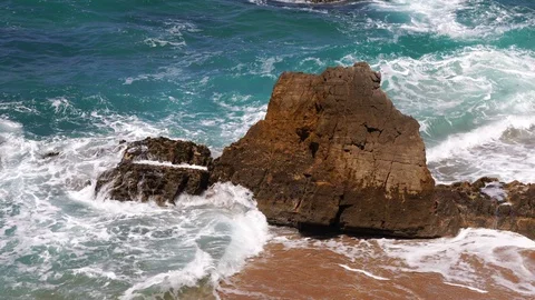 Wave crashing on the rocks of beach Stock Footage 93501905