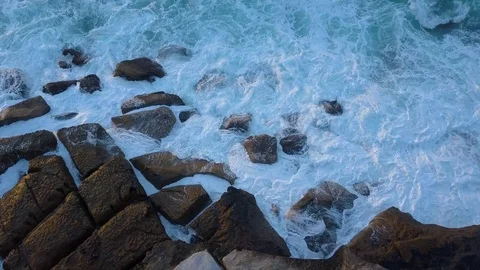 Wave crashing into rocks Stock Footage 75566779