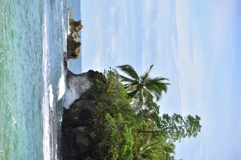 Wave crashing into tropical island Stock Photos