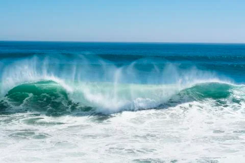 Wave crest breaking along beach Stock Photos