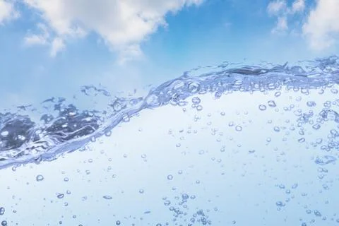 Wave of drinking water and bubble air white sky background. Stock Photos