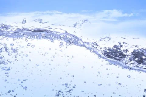 Wave of drinking water and bubble air white sky background. 写真素材