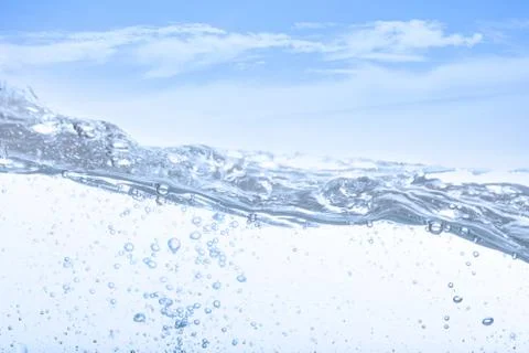 Wave of drinking water and bubble air white sky background. Stock Photos