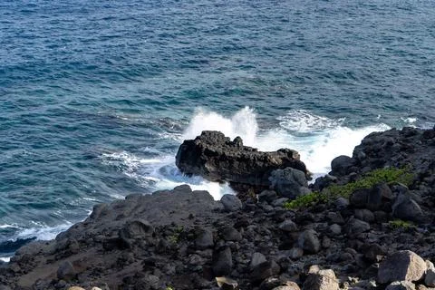 Wave exploding over a rock near Blow Hole in Maui, Hawaii Stock Photos