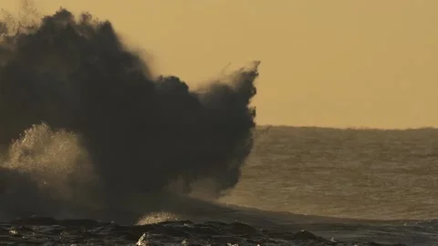 Wave Exploding on Rocks in the Golden Morning Sunrise Slow Motion Stock Footage 199425432