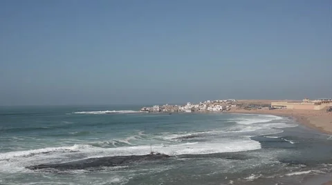 A wave front hitting the shore in a small fishing village of Tifnit Stock Footage 44783677