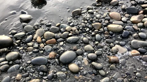 Wave Gently Washes Over An Array Of Different Sized Pebbles On Beach Stock Footage 234006899