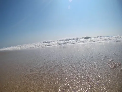 Wave hits camera on the Beach Video stock 83820092