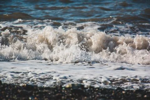 Wave hitting the beach Stock Photos