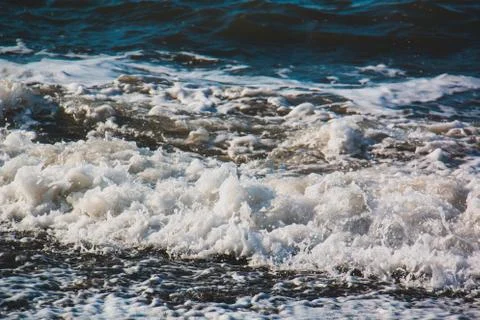 Wave hitting the beach Stock Photos